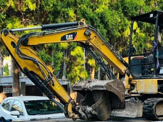 CAT mini excavator loaded on a tilt tray deck for transport in Australia
