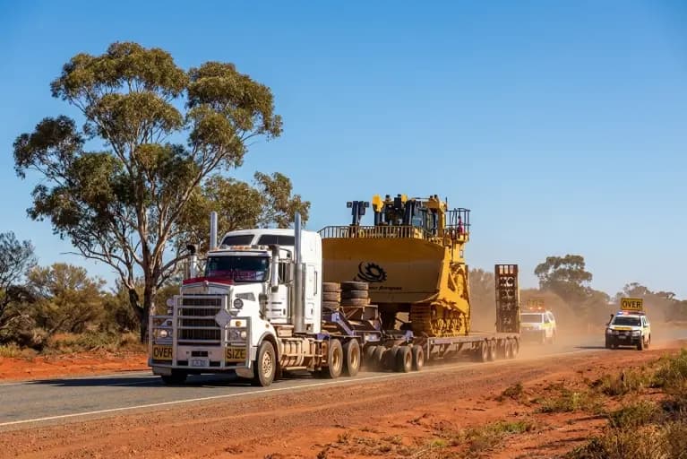 Heavy haulage truck transporting oversized mining equipment on a multi axle low loader in Western Australia