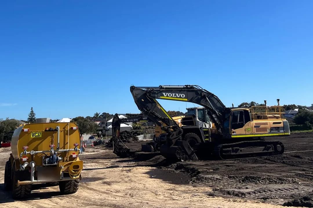 Water cart and tracked excavator on an Australian earthworks site