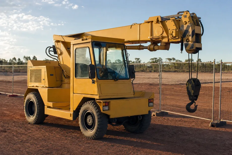 Pick-and-carry crane parked on a civil construction laydown area in Australia