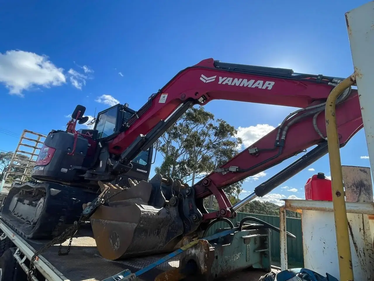 Yanmar excavator loaded on a float trailer at an Australian transport yard