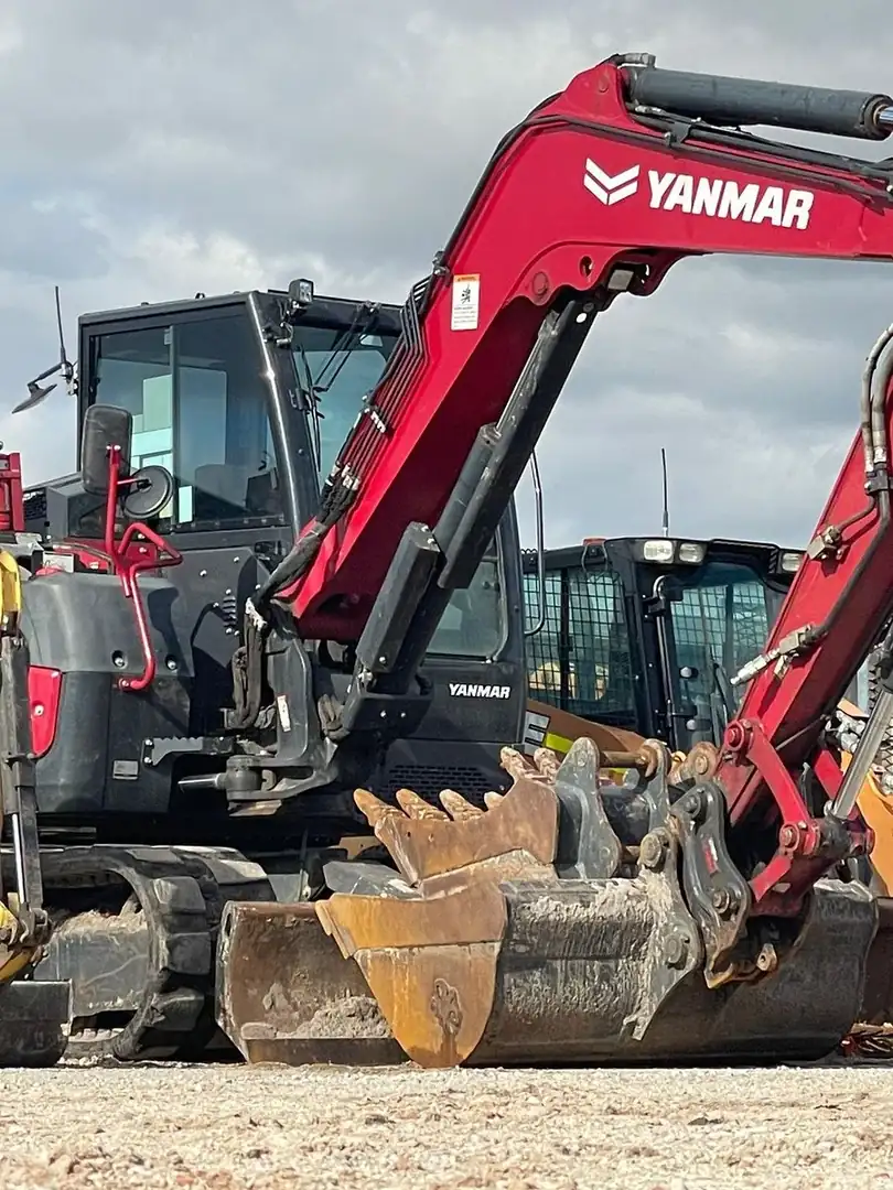 Yanmar excavator and tracked plant parked in an Australian equipment yard